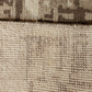 Close-up of textured beige carpet with a subtle pattern