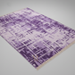 Purple geometric patterned rug on a gray background
