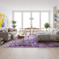 Modern living room with a purple rug, gray sofa, and dining table.
