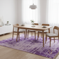 Dining room with wooden table and chairs on a purple patterned rug