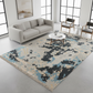 Living room with a camouflage-patterned rug, gray sofa, and modern decor.