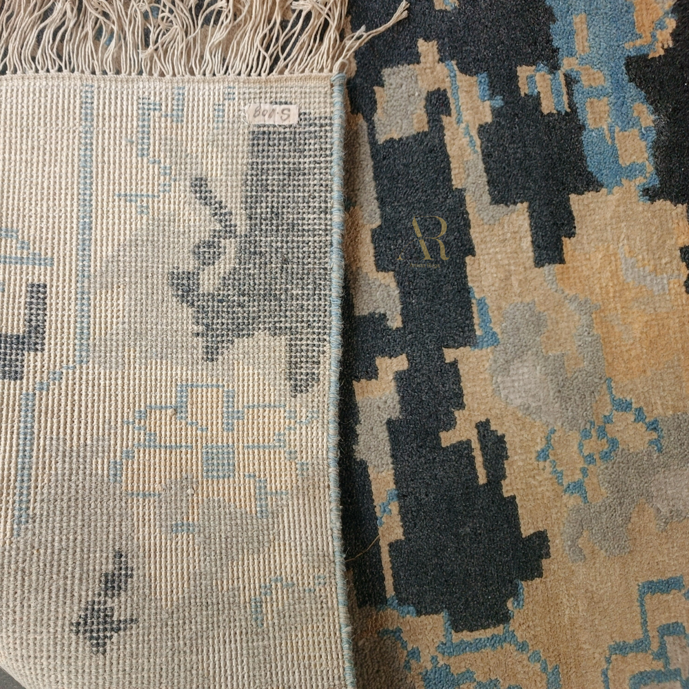 Close-up of two patterned rugs with visible brand logos.