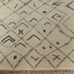 Close-up of a textured rug with geometric pattern