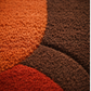 Close-up of textured orange, brown, and red fabric