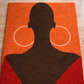 Rug with a silhouette of a person wearing large hoop earrings on an orange background