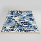 Blue and white abstract patterned rug on a gray background