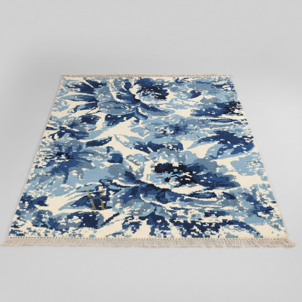 Blue and white abstract patterned rug on a gray background