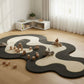 Children's playroom with a large abstract rug on a wooden floor.