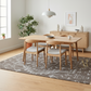 Dining room with wooden table and chairs on a patterned rug