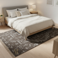 Bedroom with a bed, nightstands, and a patterned rug.