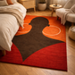Decorative rug with abstract design in a bedroom setting