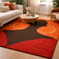 Living room with a colorful abstract rug, sofa, and coffee table.
