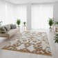 Living room with a patterned rug, sofa, and plants
