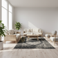 Modern living room with light wood furniture, white cushions, and a dark patterned rug.