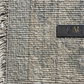 Textured fabric with a ruler for scale on a gray background