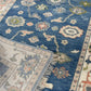 Close-up of a blue patterned rug with intricate designs