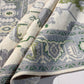Close-up of a patterned rug with geometric designs in green, gray, and white.