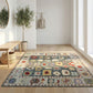 Decorative rug with floral pattern on a wooden floor in a bright room.
