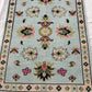Decorative rug with floral patterns on a light blue background