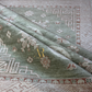 Close-up of a patterned fabric with geometric and floral designs.