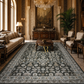 Luxurious living room with ornate furniture and a large patterned rug.