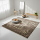 Brown patterned rug in a room with a dog lying on a gray pet bed.