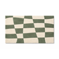 Checkered green and beige rug on a white background