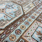 Close-up of a patterned rug with geometric and floral designs.
