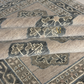 Close-up of a patterned rug with geometric designs.