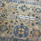 Decorative rug with intricate patterns and a visible brand label at the bottom.