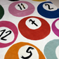 Colorful circular patterns with numbers and tools on a textured surface