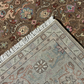 Close-up of two patterned rugs with a visible transition area.