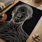 Black rug with white line art of a face in a living room setting