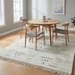 Dining room with wooden table and chairs on a patterned rug