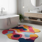 Colorful abstract rug in a modern bathroom with a bathtub and sink.