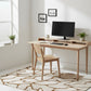 Modern home office with a wooden desk, chair, and computer setup.