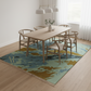 Dining room with a colorful rug, wooden table, and chairs.