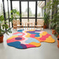 Colorful abstract rug on a light gray floor with a modern room in the background