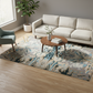 Living room with a patterned rug, sofa, and coffee table.