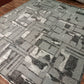 Gray geometric patterned rug on a wooden floor