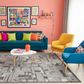 Colorful living room with a blue sofa, yellow chair, and colorful decor.