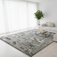 Living room with a large gray patterned rug, white sofa, and coffee table.