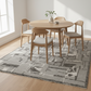Dining room with wooden table and chairs on a geometric patterned rug.
