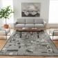 Living room with a gray sofa, coffee table, and patterned rug.