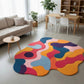 Colorful abstract rug in a living room setting with a sofa, coffee table, and dining area.