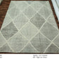 Woven rug with geometric pattern on a wooden floor