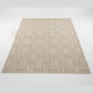 Beige woven patterned rug on a white background