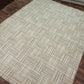 Beige patterned rug on a wooden floor