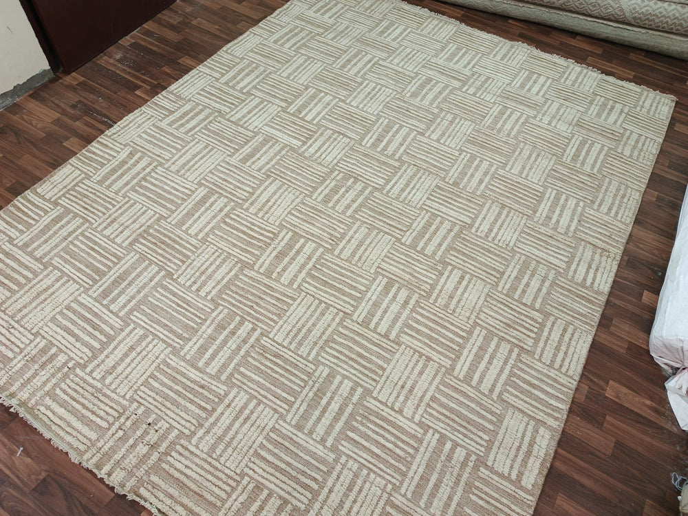 Beige patterned rug on a wooden floor
