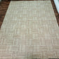 Beige patterned rug on a wooden floor